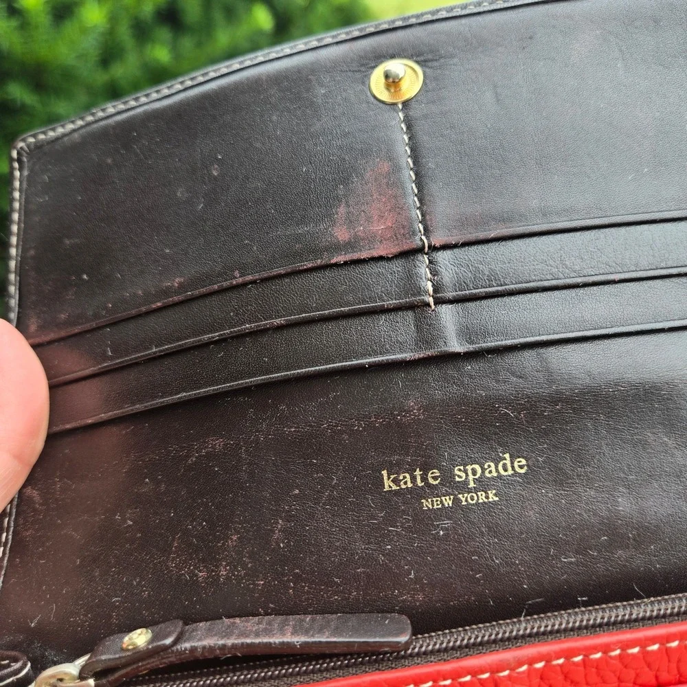 kate spade bifold pebble leather wallet. In red. Flaws